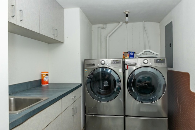 laundry room with a sink, cabinet space, and separate washer and dryer