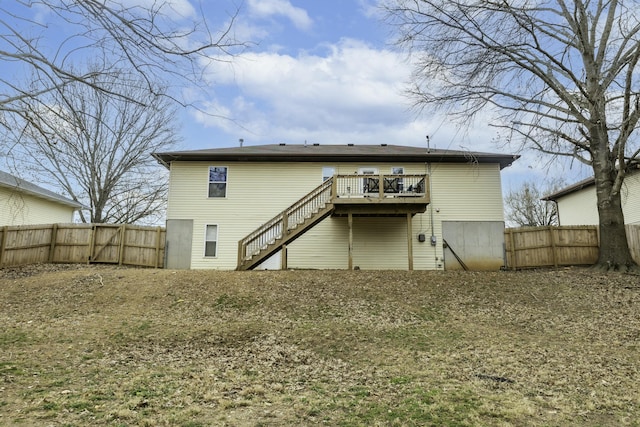 back of house with stairway, a deck, and fence