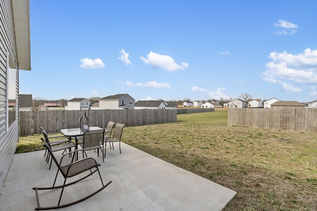 view of patio / terrace featuring outdoor dining area, a fenced backyard, and a residential view