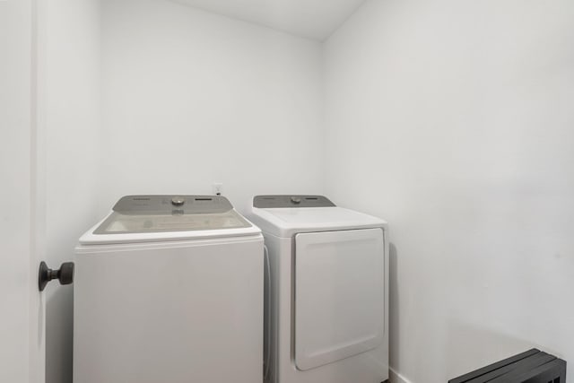 washroom featuring separate washer and dryer and laundry area