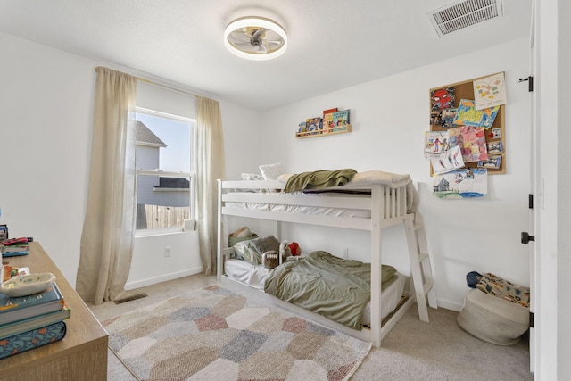 carpeted bedroom featuring baseboards and visible vents