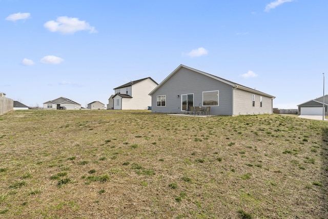 back of house with a patio area, fence, and a lawn