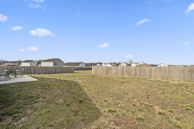 view of yard featuring a residential view, a patio, and fence