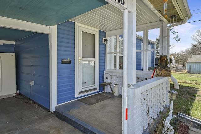 view of exterior entry featuring a porch