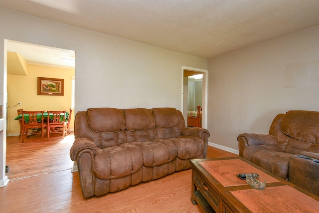 living room with light wood-style flooring and baseboards