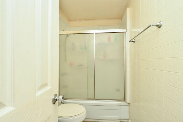 bathroom with toilet and enclosed tub / shower combo