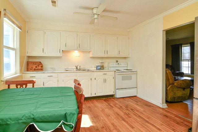 kitchen featuring crown molding, electric range, visible vents, and a sink