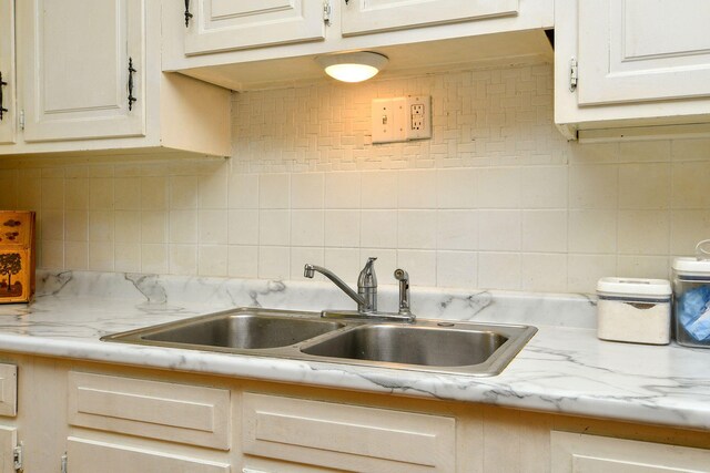 kitchen with a sink and backsplash