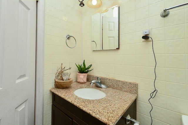 bathroom featuring tile walls and vanity