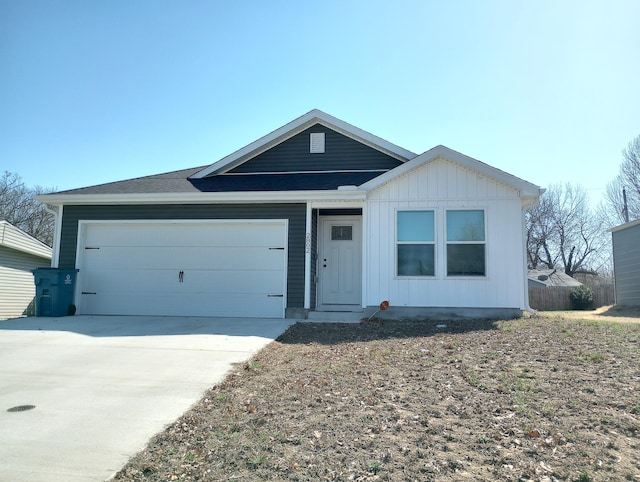 ranch-style house with an attached garage and concrete driveway