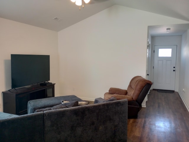 living area featuring visible vents, dark wood-type flooring, baseboards, vaulted ceiling, and a ceiling fan