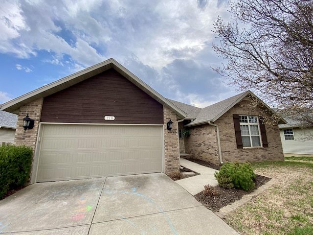 ranch-style house with brick siding, concrete driveway, an attached garage, and a shingled roof