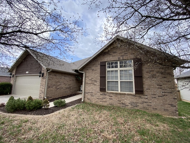 ranch-style home featuring brick siding, roof with shingles, concrete driveway, and an attached garage