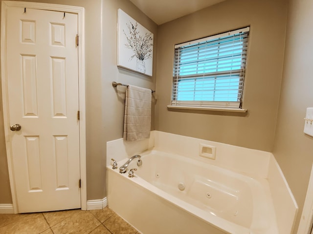 full bath with tile patterned flooring, a jetted tub, and baseboards