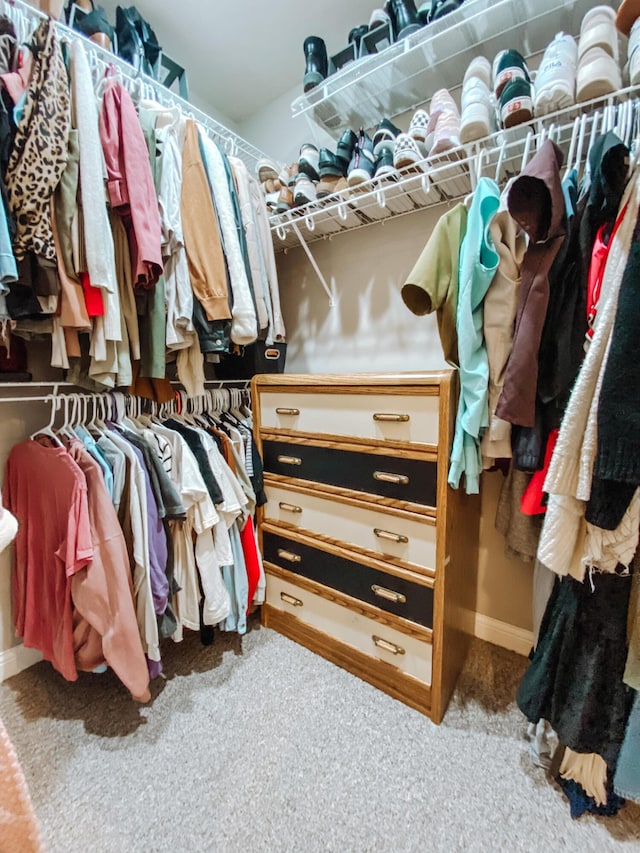 walk in closet with carpet