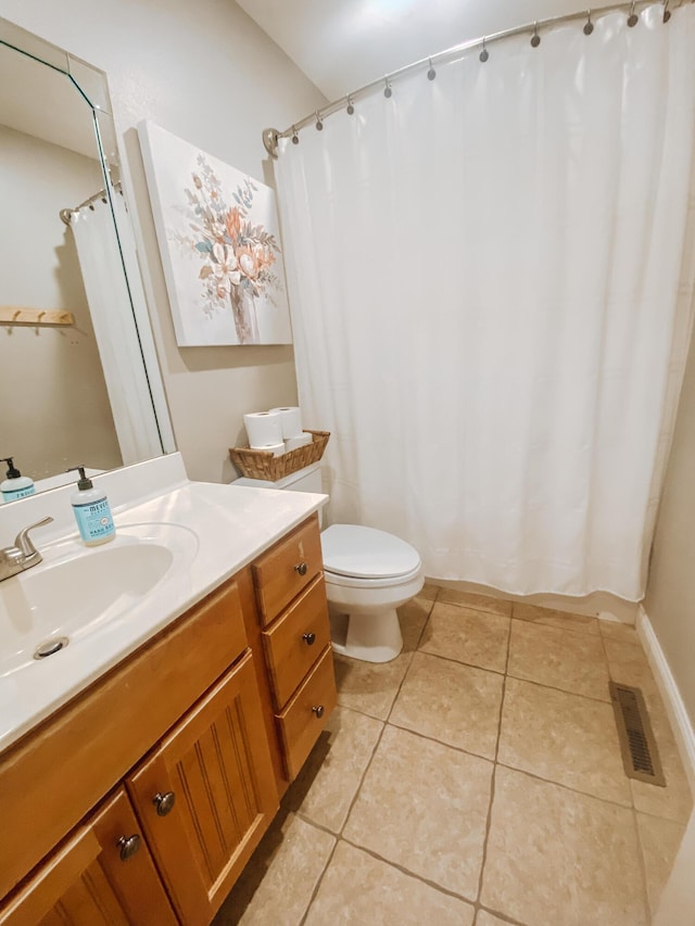 bathroom featuring vanity, a shower with shower curtain, visible vents, tile patterned floors, and toilet