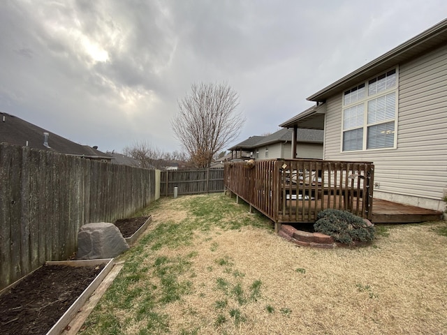 view of yard with a fenced backyard and a wooden deck