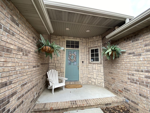 property entrance featuring brick siding