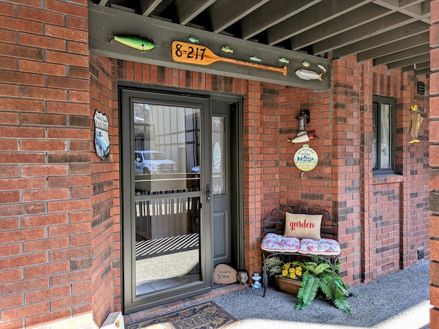 property entrance with brick siding