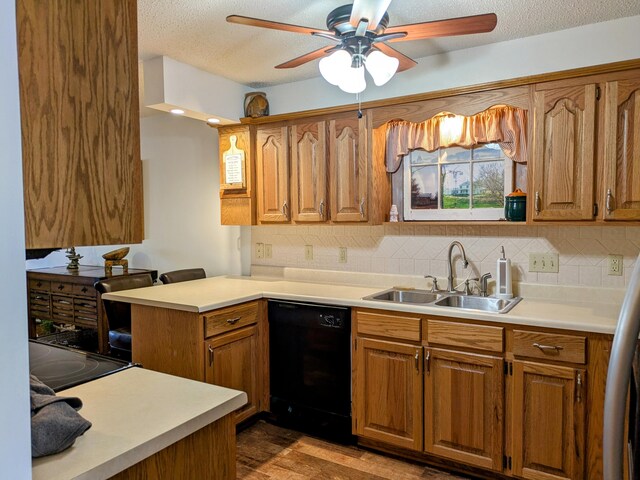 kitchen featuring ceiling fan, light countertops, black dishwasher, and a sink