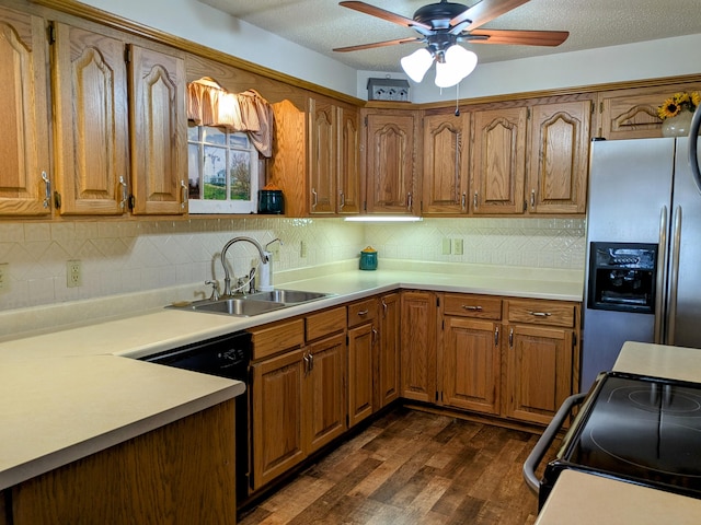 kitchen with black appliances, a ceiling fan, a sink, brown cabinetry, and light countertops