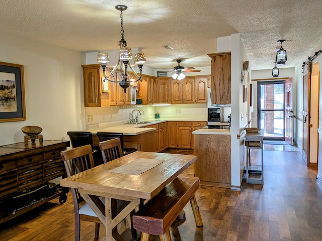 kitchen featuring dark wood finished floors, light countertops, and a sink