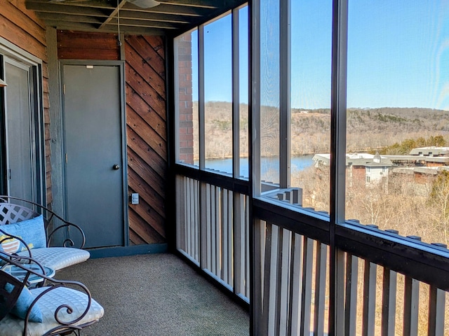 unfurnished sunroom with a water view