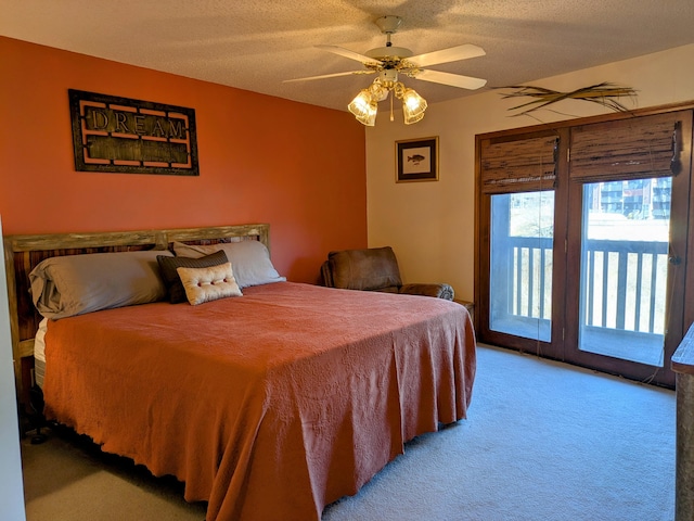 bedroom with a ceiling fan, a textured ceiling, carpet flooring, and access to outside