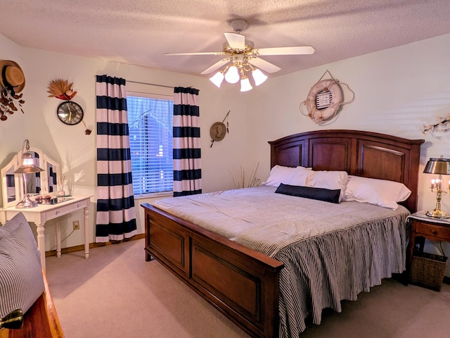 bedroom with light colored carpet, a textured ceiling, and ceiling fan