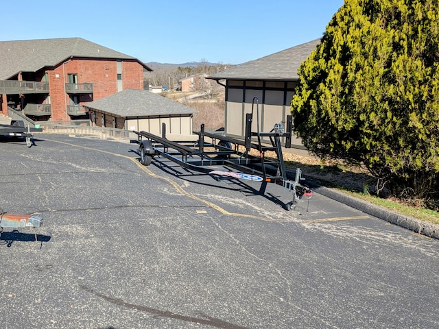 exterior space with a mountain view, a shingled roof, and a garage