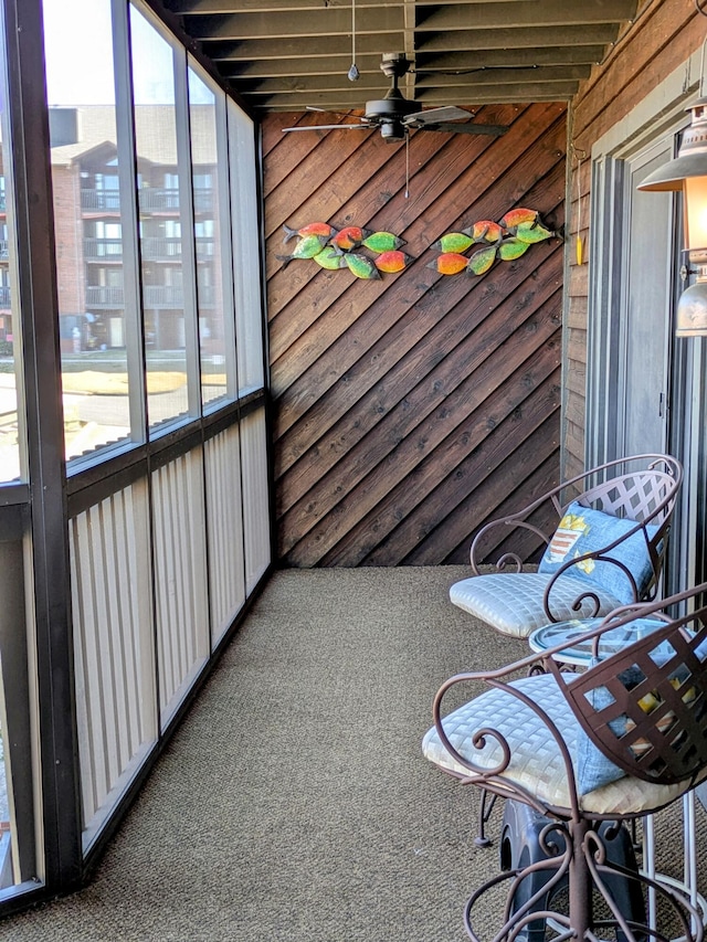 unfurnished sunroom with ceiling fan