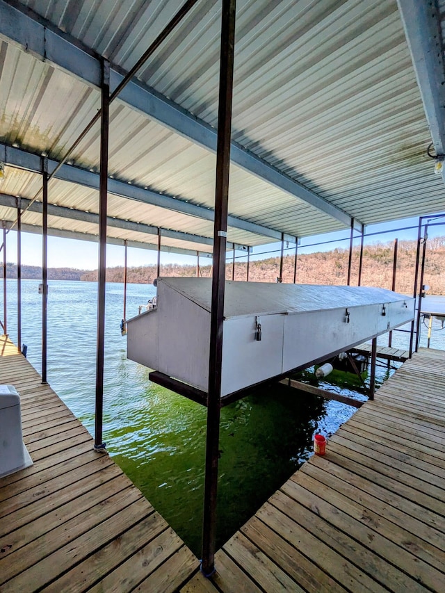 dock area with a water view and boat lift