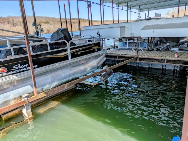 dock area with a water view and boat lift