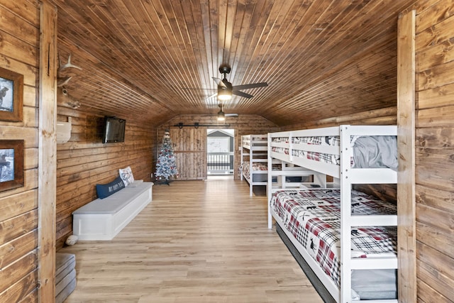 unfurnished bedroom featuring wooden walls, wood finished floors, wooden ceiling, and vaulted ceiling