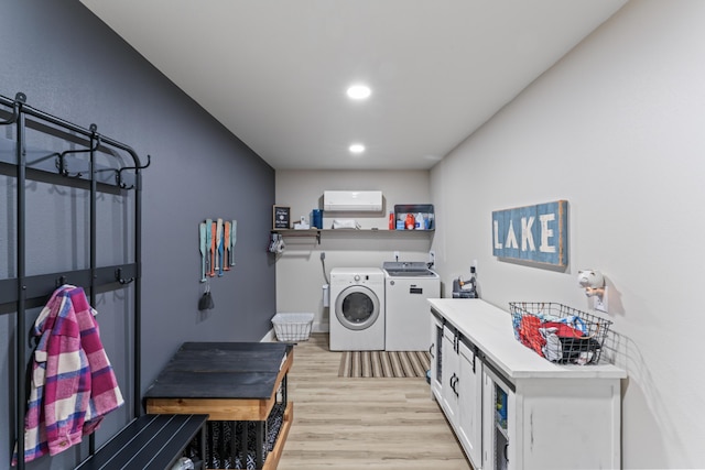 laundry room featuring recessed lighting, light wood-type flooring, and washing machine and dryer