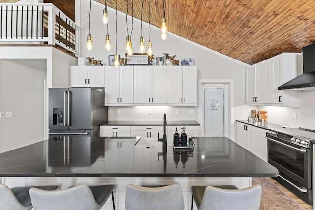 kitchen featuring dark countertops, wooden ceiling, stainless steel appliances, and vaulted ceiling