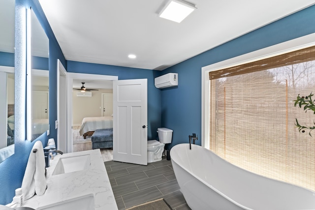 ensuite bathroom with a wall mounted AC, ensuite bath, a freestanding tub, a sink, and toilet