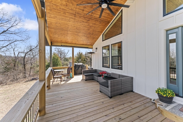 wooden terrace featuring outdoor lounge area and ceiling fan