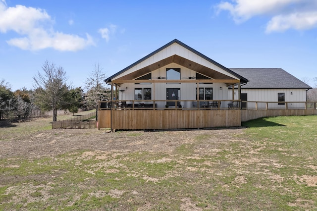 rear view of property featuring fence and board and batten siding