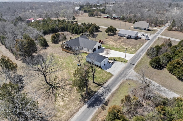 aerial view featuring a forest view and a rural view