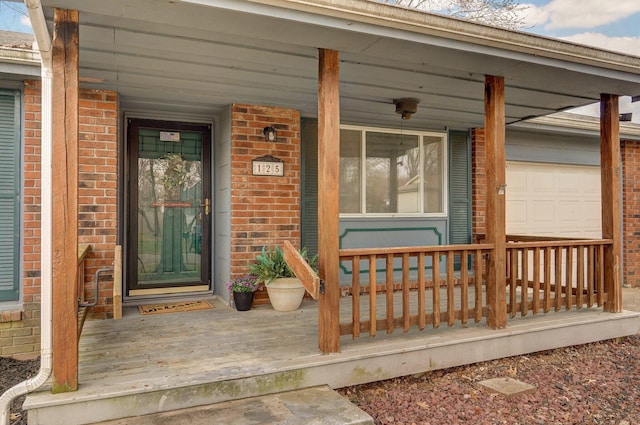 doorway to property with brick siding and covered porch