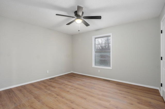 unfurnished room with light wood-style floors, baseboards, and ceiling fan