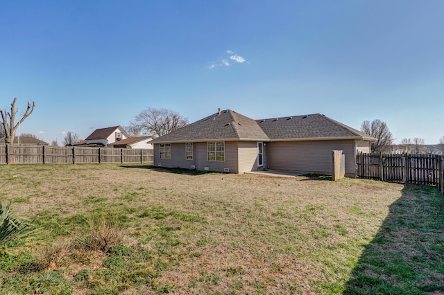 back of house featuring a patio, a yard, and a fenced backyard