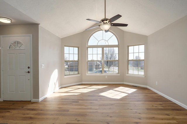 foyer entrance featuring baseboards, wood finished floors, and ceiling fan