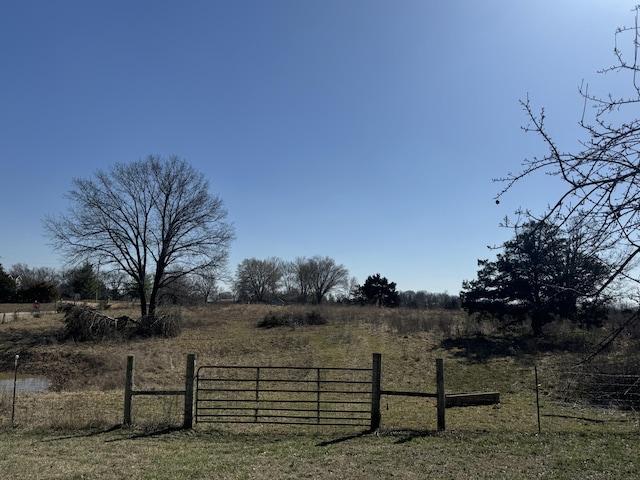 view of yard featuring a rural view and fence