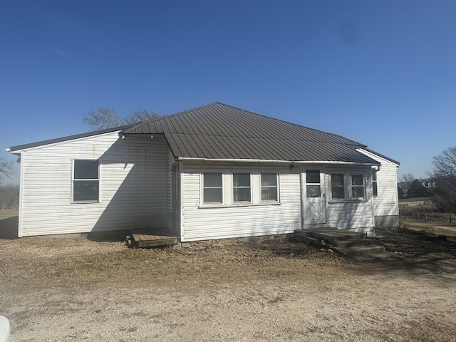 back of property with metal roof