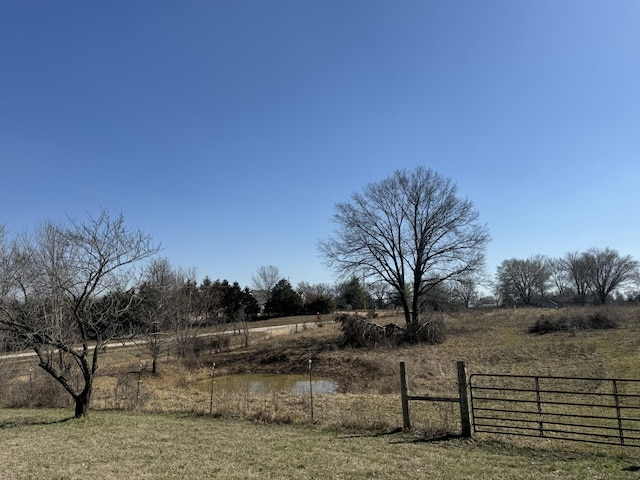 view of yard featuring a rural view and fence