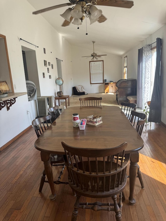 dining room with baseboards, lofted ceiling, ceiling fan, and hardwood / wood-style flooring