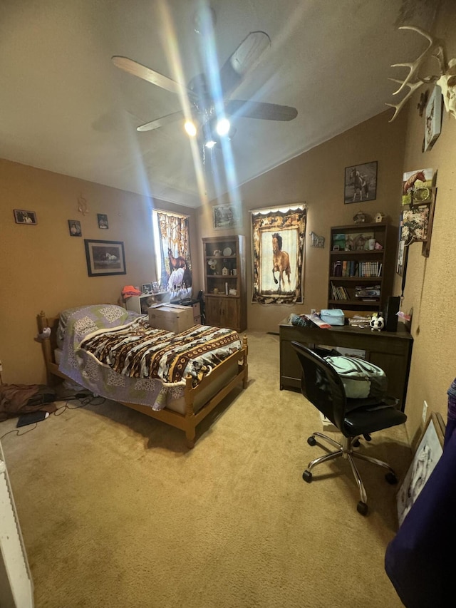 carpeted bedroom featuring vaulted ceiling and ceiling fan