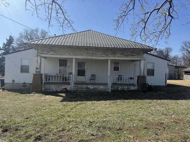 back of house featuring a porch and a lawn